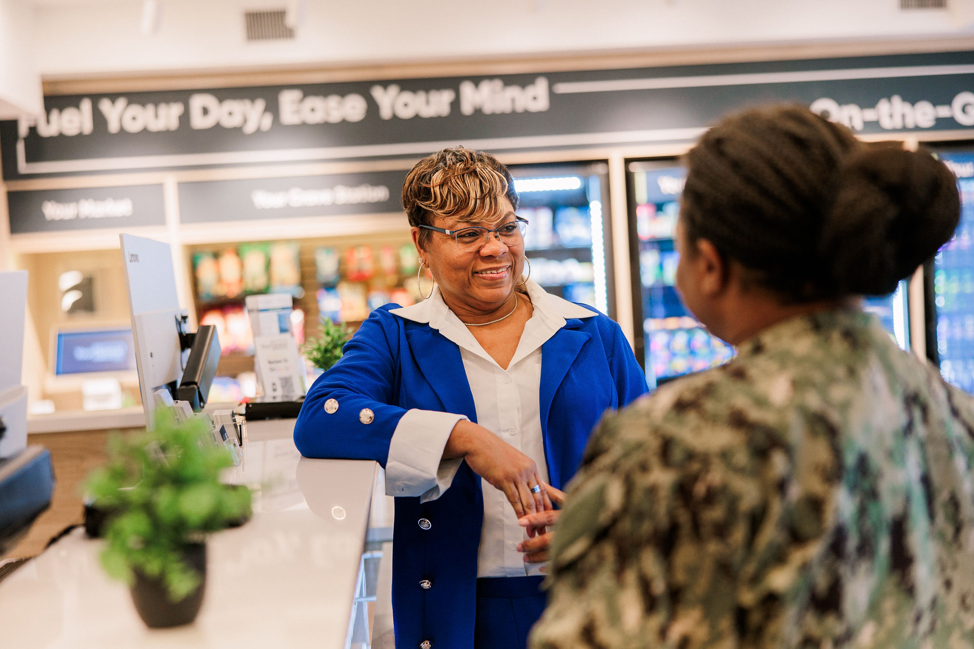 Hotel team member greeting a long-term guest at YourSpace Hotels Chesapeake, representing friendly, personalized service.