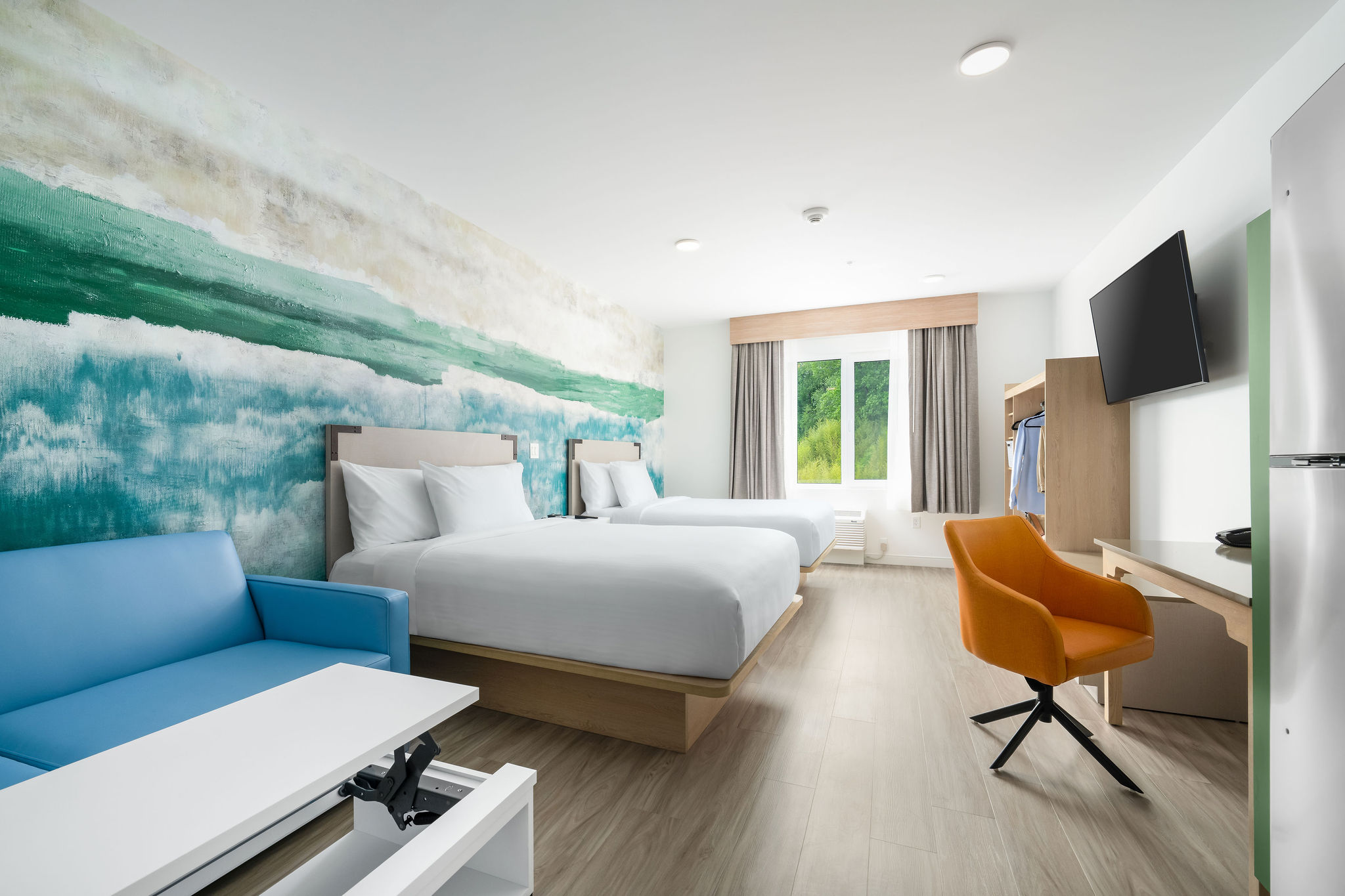 Guests enjoying extended-stay amenities at YourSpace Hotel Chesapeake, including in-suite kitchens, private washers and dryers, patio BBQ grills, EV charging, and comfortable modern suites.
