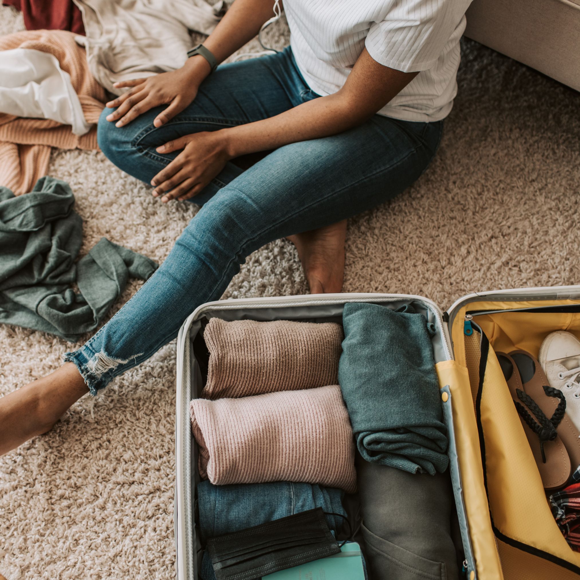 Business travel hotel with extended-stay suites in Chesapeake, VA. Business traveler packing a suitcase in a modern extended-stay suite at YourSpace Hotels Chesapeake.